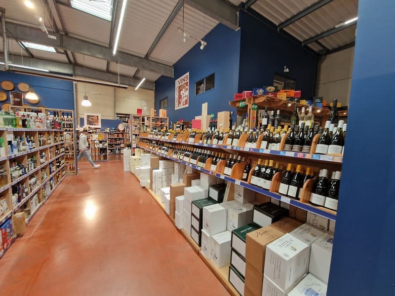 Inside Calais Vins store showing large wine selection and aisles